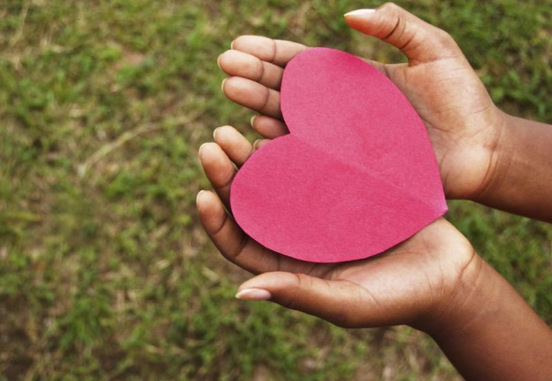 picture of a pair of hands holding a paper heart