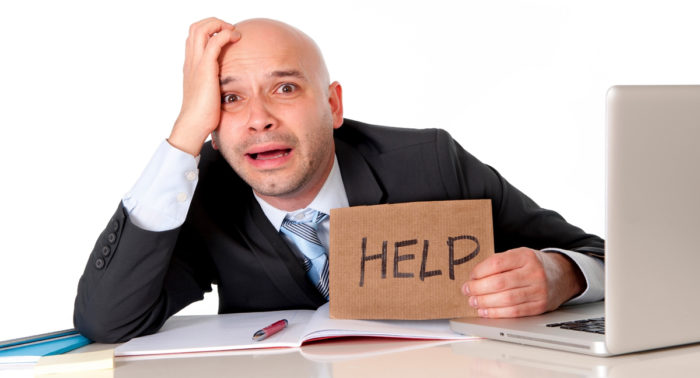 picture of a stressed out worker holding a sign saying help non-profit management