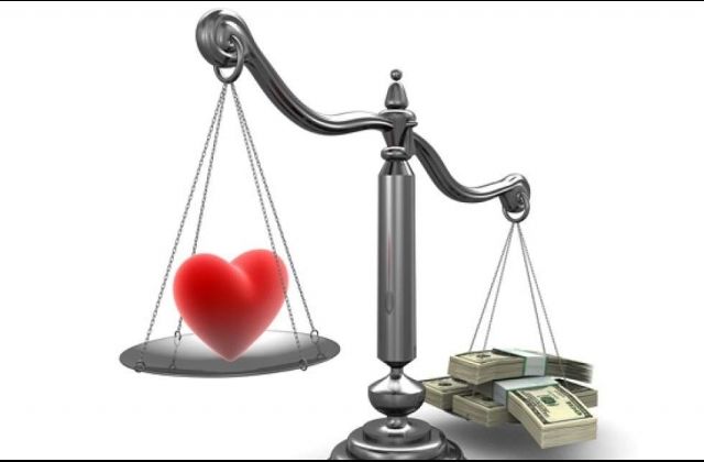 Scale of heart vs. money.