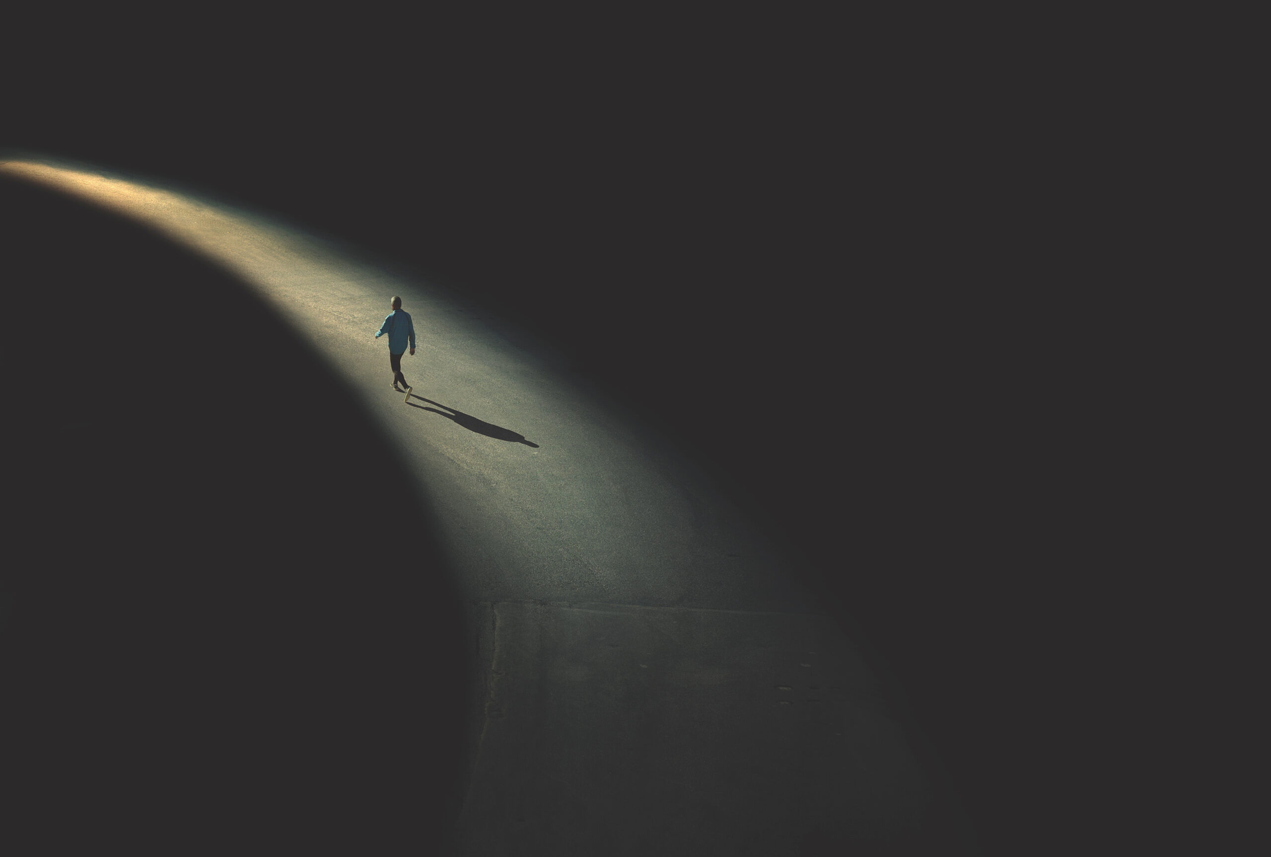 A man walking alone toward a light, symbolizing older donors. Death, Dying, and Major Gifts