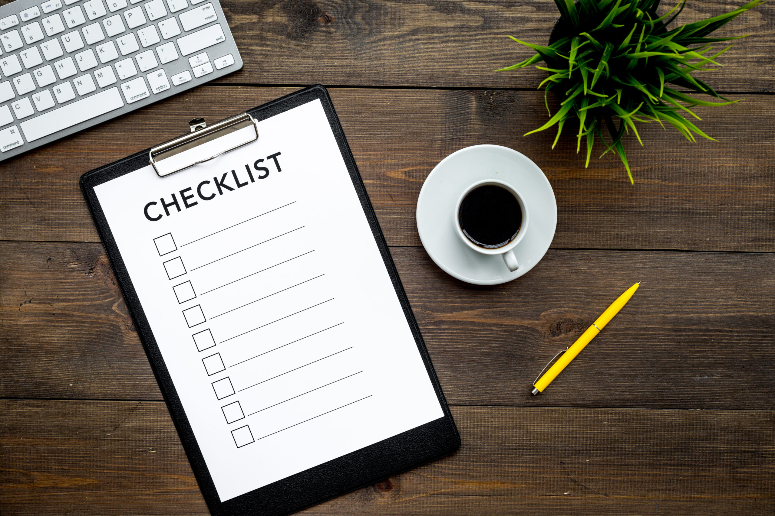 Image of a desk with a checklist on a clipboard [Get Your Caseload Management Checklist!]