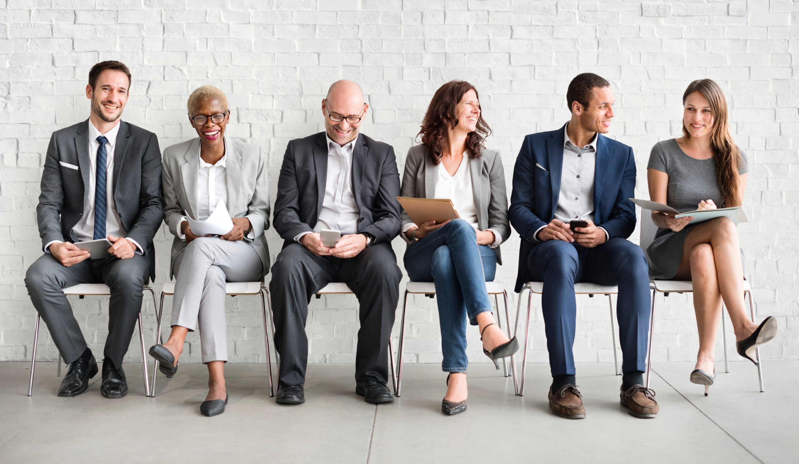 Group of diverse people waiting for a job interview. [Six Skills to Look for When Hiring a Fundraiser Without a Fundraising Background]