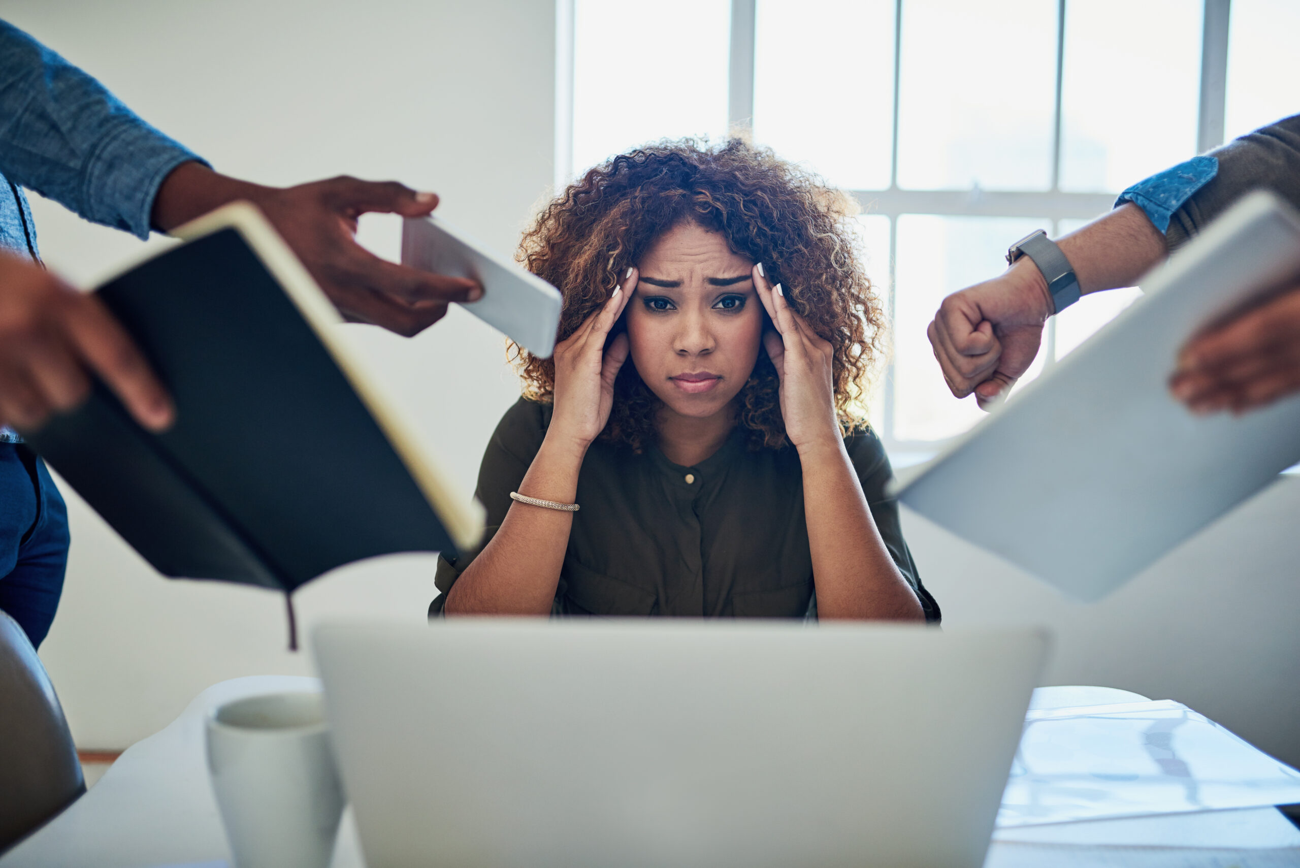 A fundraiser looks stressed out as people keep handing her more tasks [Does Your Fundraiser Have Time for Fundraising?]
