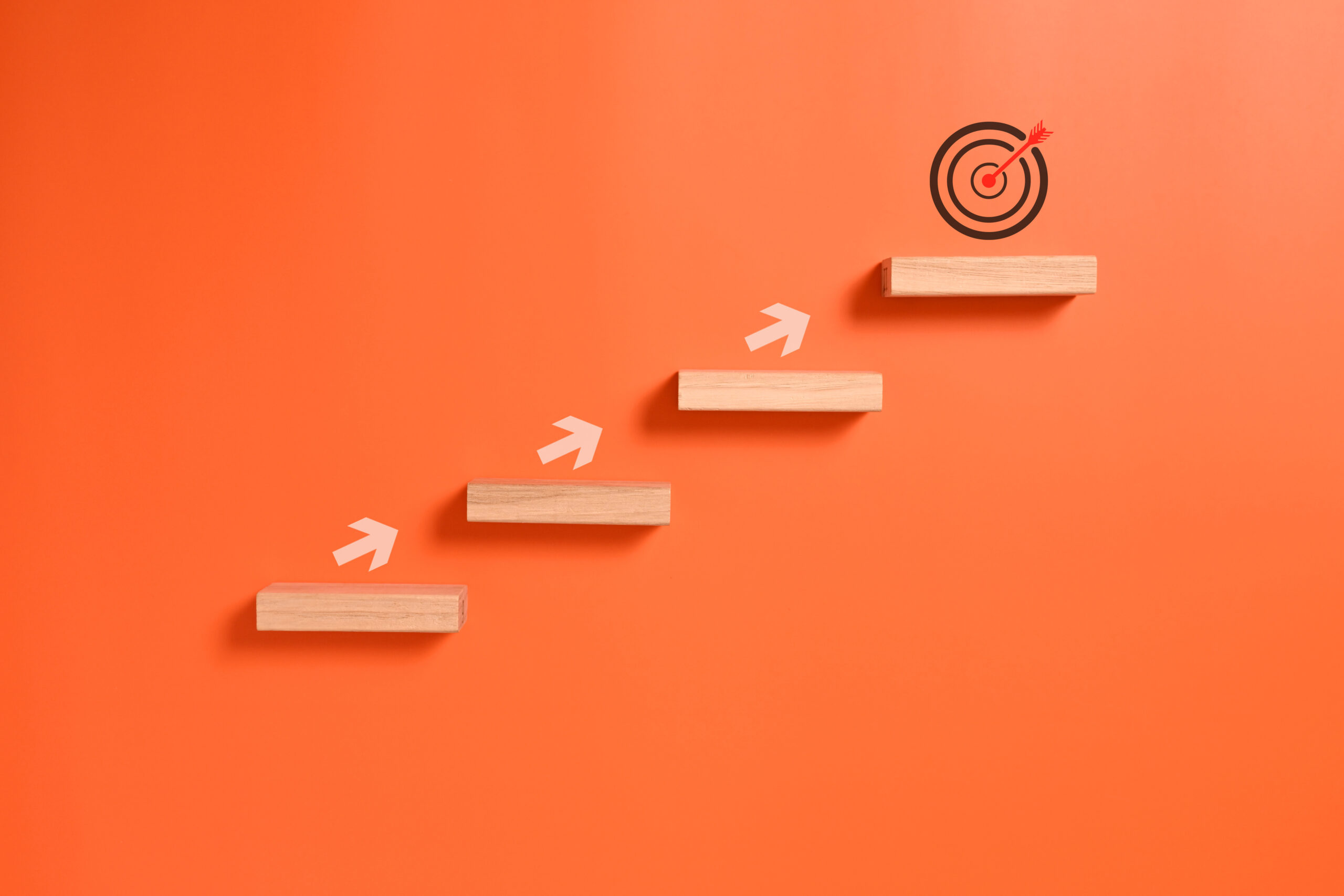 Arrows climbing steps toward a target [How to Level Up as a Fundraiser in 2024: Choose Your Growth Path!]