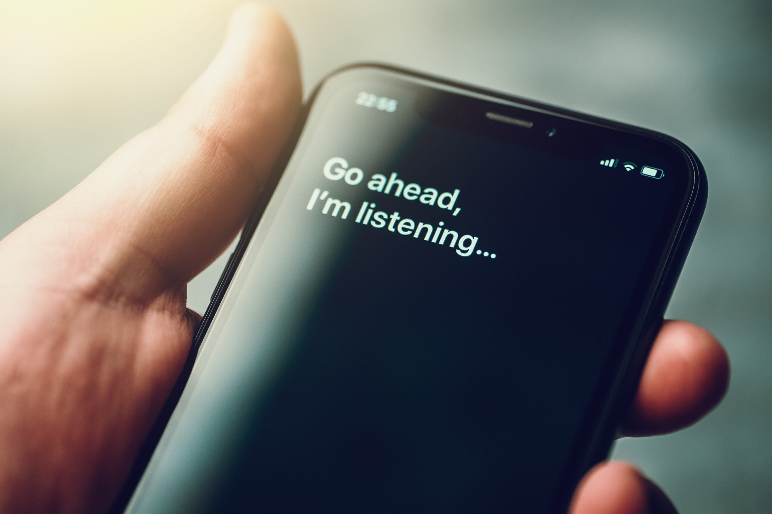 A phone screen showing an AI chat that starts with: "Go ahead, I'm listening..."