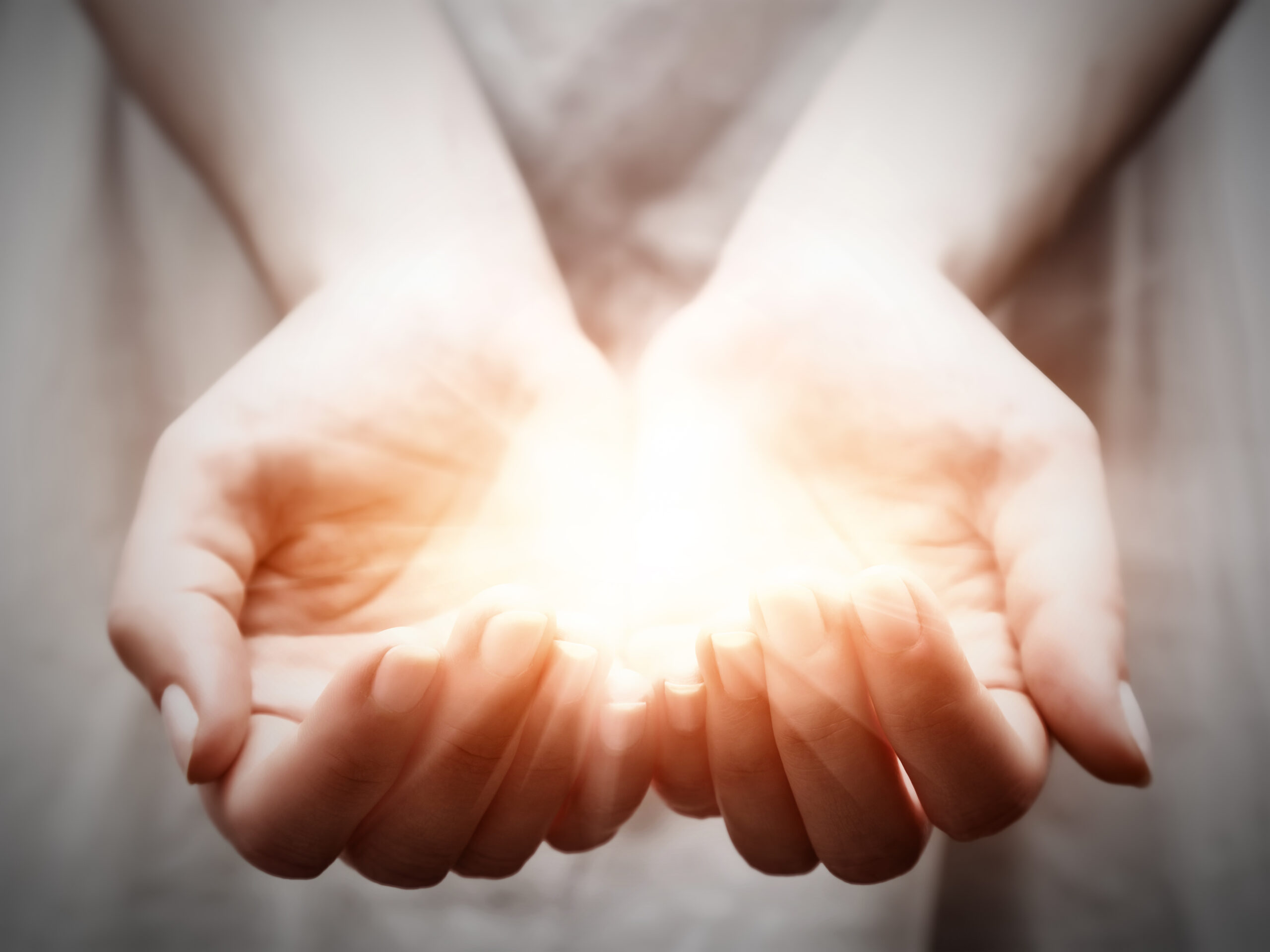 Hands holding light, representing donor offers