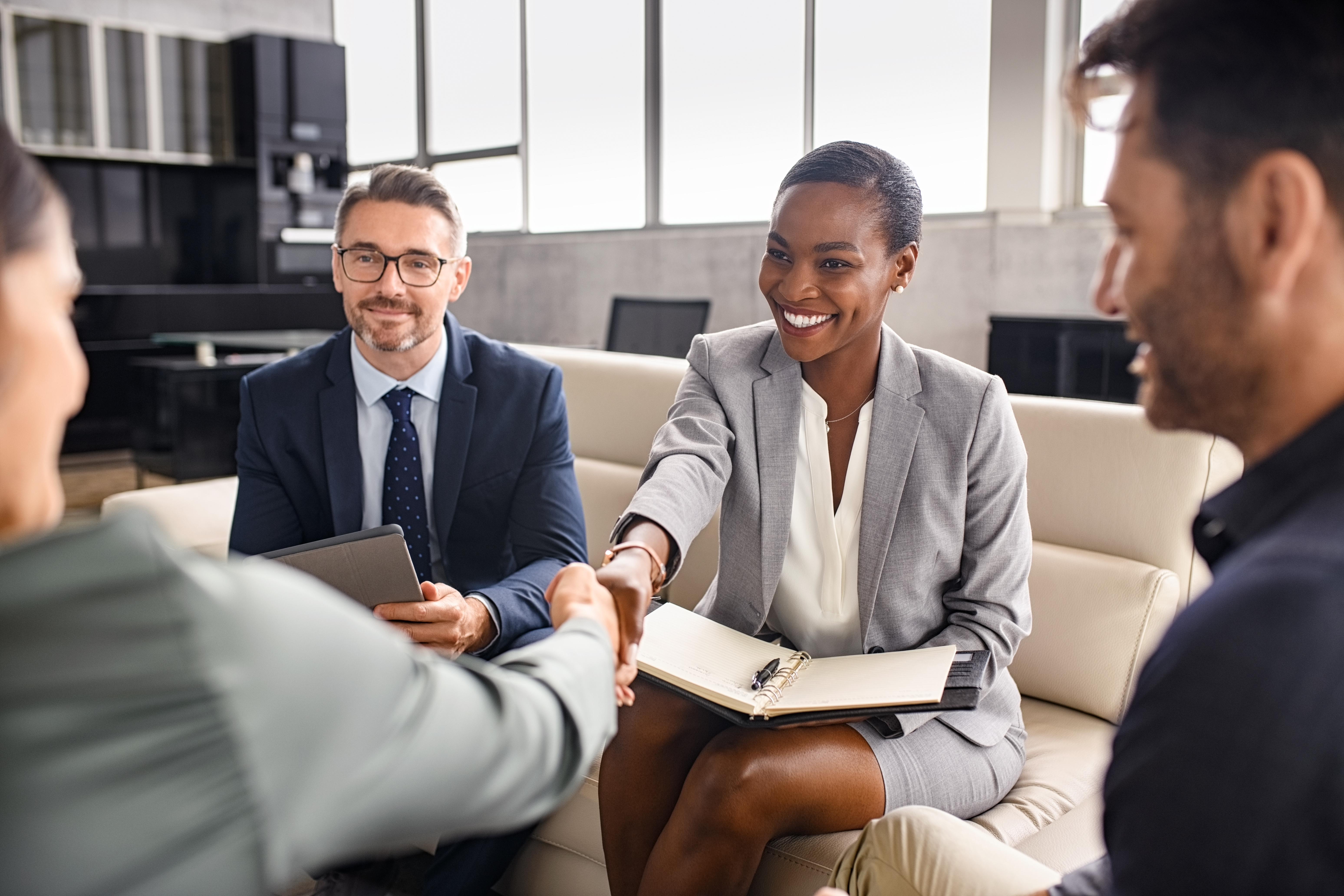 Smiling major gift officer shakes donor's hand at beginning of donor meeting.[The Four Steps to Better Donor Meetings Begin with You]