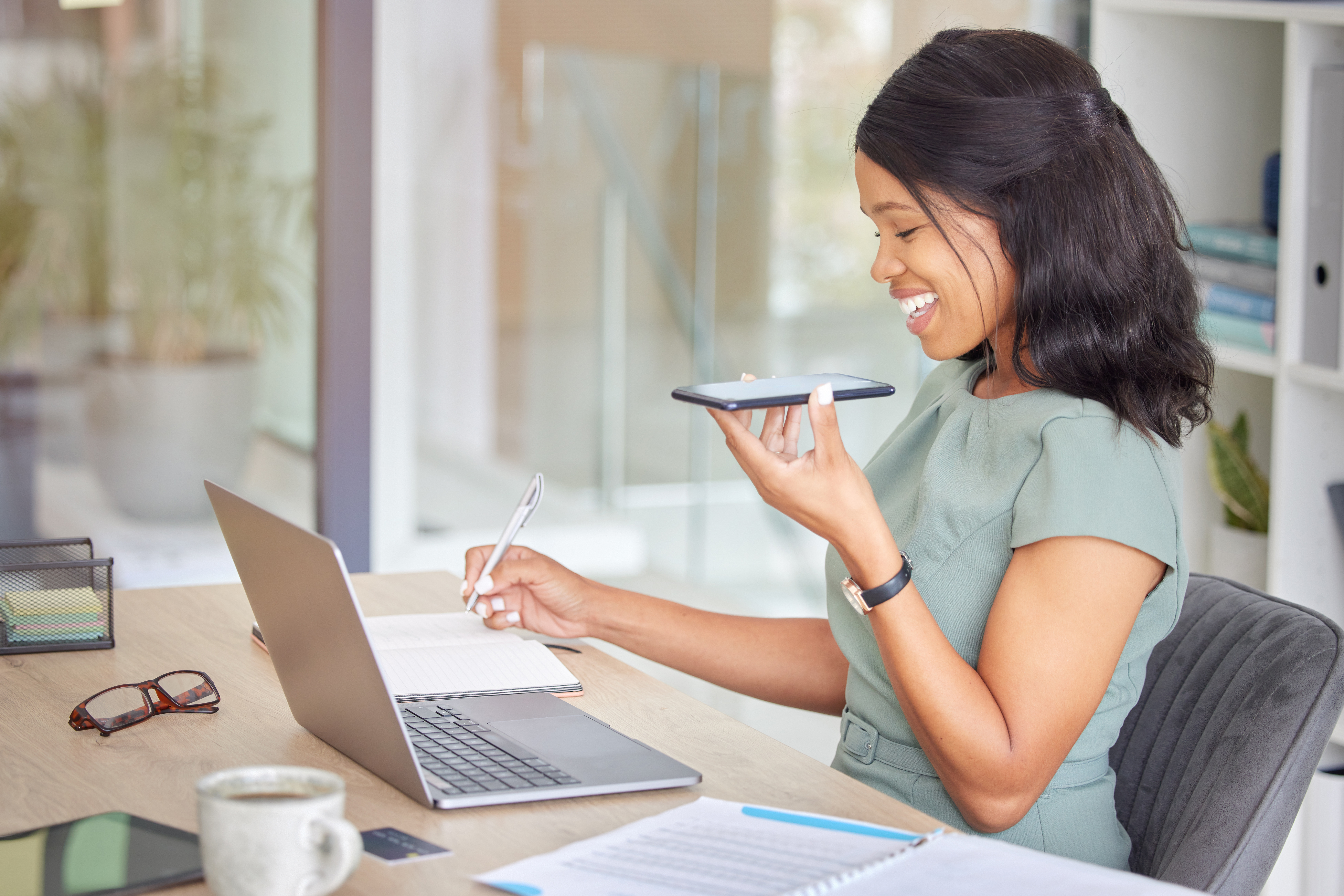 Business woman, phone call and talking with laptop, for conversation and planning. [Get Your Donor Calling Muscles with this Checklist]